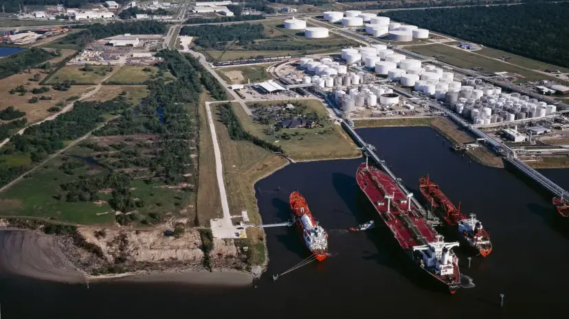 Tankers docked along the Houston Ship Channel beside storage tanks
