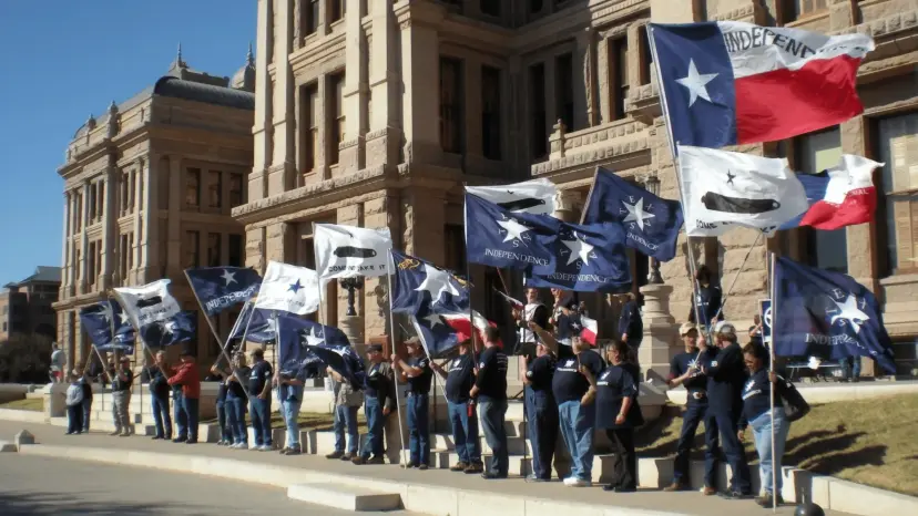 Texas Nationalist Movement supporters holding Texas flags along the grounds of the Texas State Capitol in Austin.