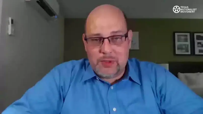 A bald man in glasses and a blue shirt speaks on a livestream with the TNM logo.