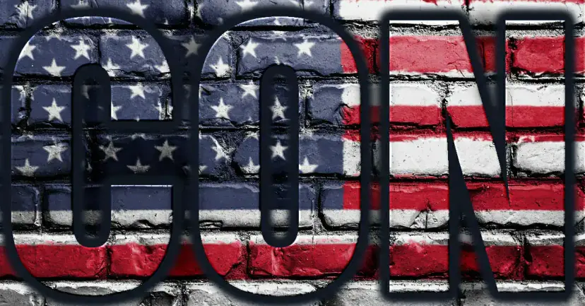 Graphic reading "Con" in large dark letters over an American flag painted on a brick wall.