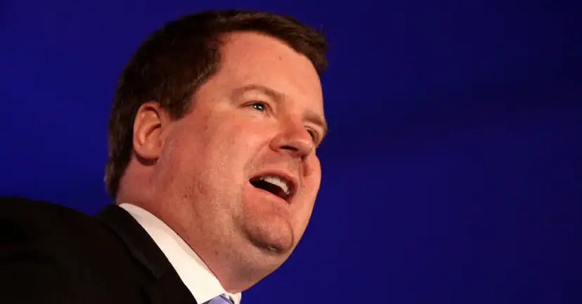 Erick Erickson speaking with his mouth open against a dark blue background.