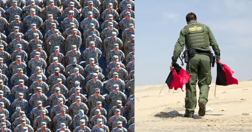 Rows of uniformed soldiers beside a Border Patrol agent walking across sand carrying red and black flags.