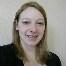 Headshot of a smiling young woman with shoulder length light brown hair.