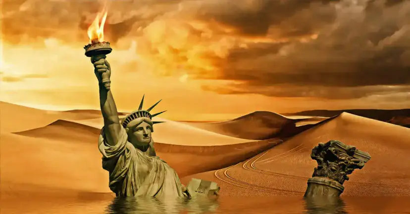 The Statue of Liberty and a broken column half buried in desert sand dunes under an orange sky.
