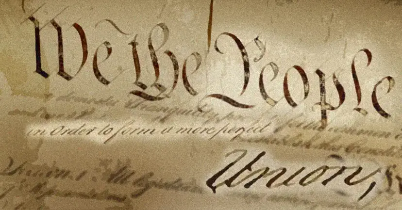 Close view of the handwritten words "We the People" and "Union" on the parchment of the Constitution.