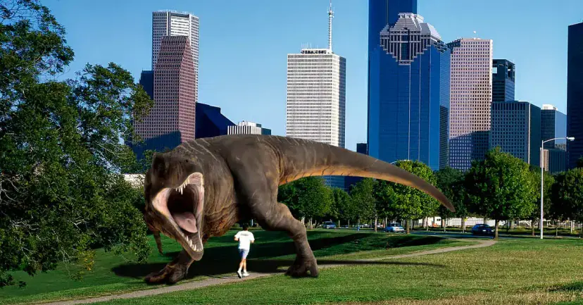 A roaring Tyrannosaurus rex chasing a jogger through a park in front of the Houston skyline.