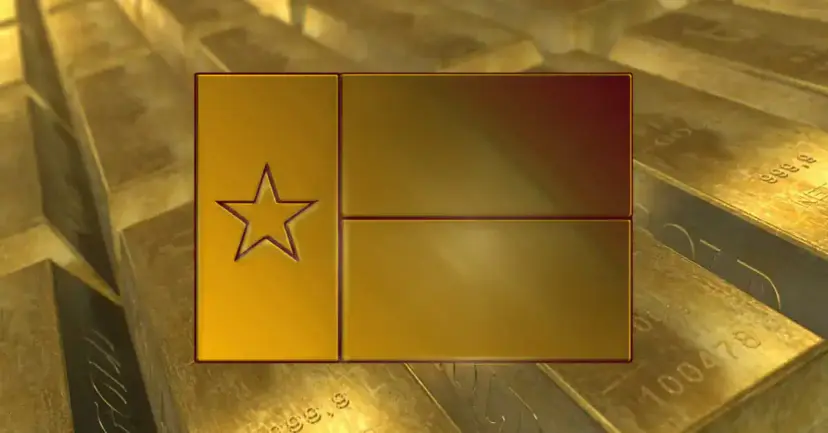 Texas flag embossed on a gold bar resting on a stack of gold bullion bars.