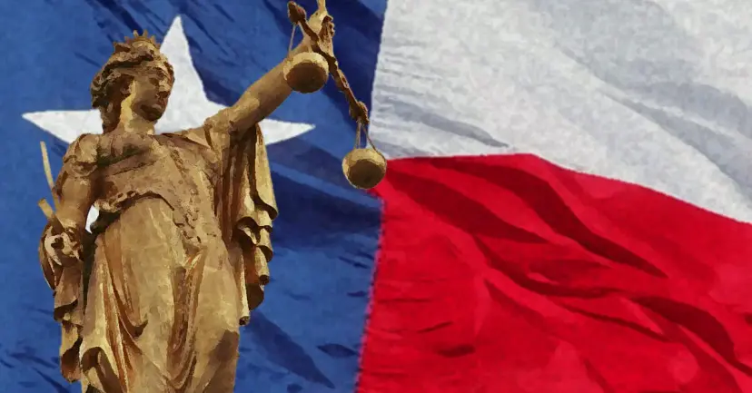 Golden statue of Lady Justice holding scales in front of a waving Texas flag.