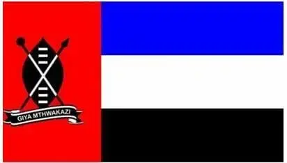 Matabeleland flag with a red panel showing a shield, crossed spears and "Giya Mthwakazi" beside blue, white and black stripes.