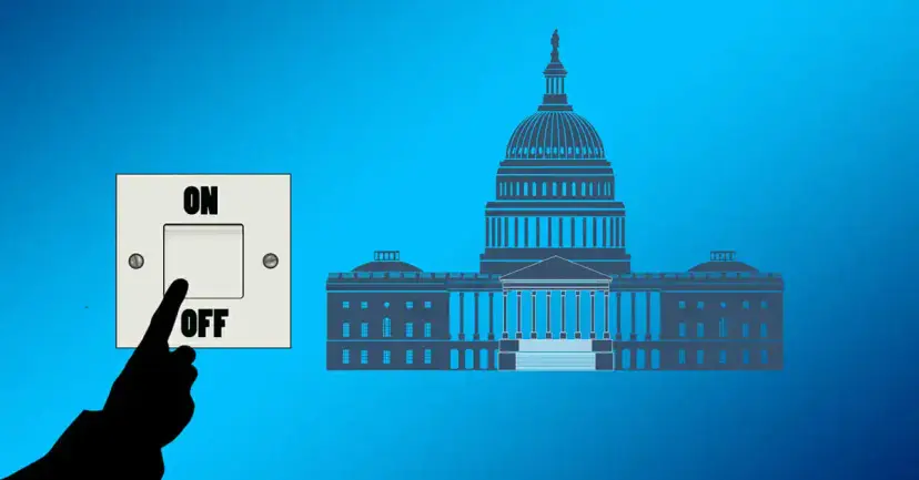 A silhouetted finger pressing a light switch to "Off" beside a drawing of the U.S. Capitol.
