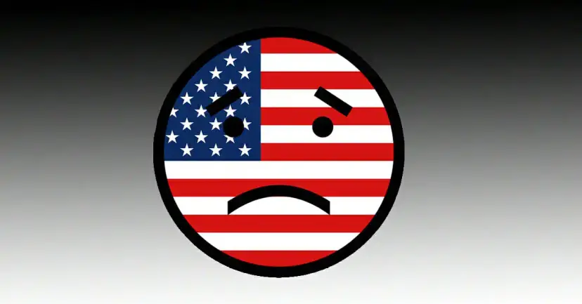 Cartoon frowning face made from the American flag against a black to white background.