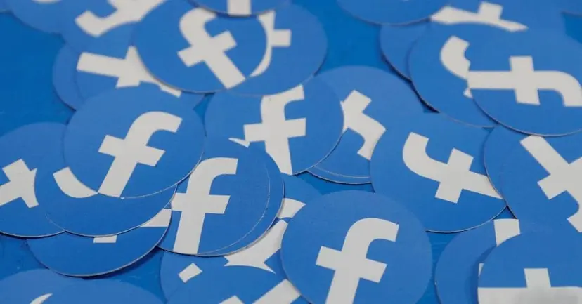 A pile of round blue stickers with the white Facebook logo.