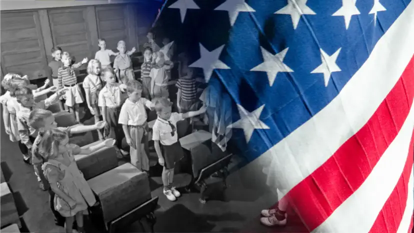 Black and white schoolchildren saluting the flag in a classroom, blended into a waving American flag.