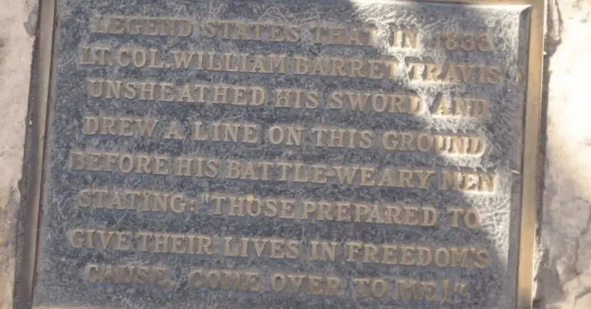 Bronze plaque describing the legend of Lt. Col. William Barret Travis drawing a line on the ground.