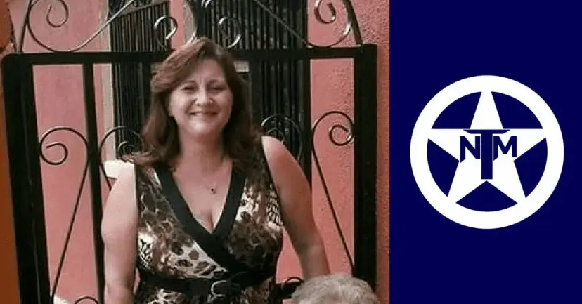 Smiling woman in a patterned dress standing at an iron gate, beside the white TNM star logo on navy.