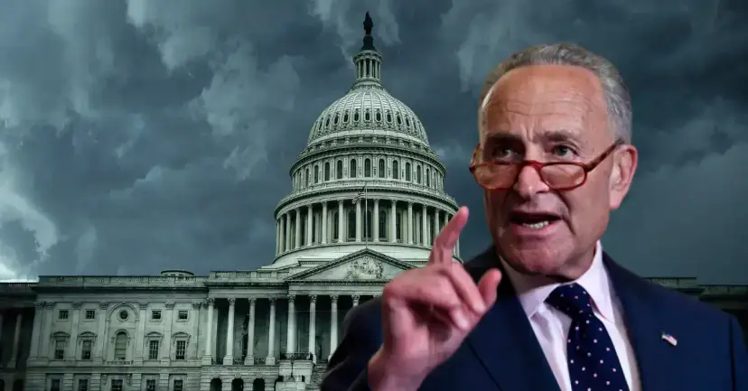 Senator Chuck Schumer points a finger in front of the U.S. Capitol under dark storm clouds.