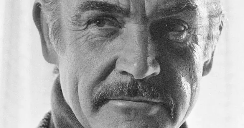 Black and white close-up portrait of actor Sean Connery.