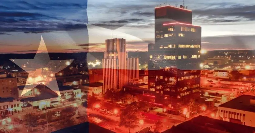 Downtown city skyline at dusk overlaid with a translucent Texas flag.