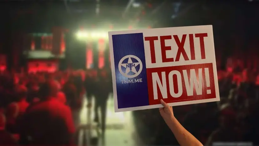 A hand holds up a 'TEXIT Now!' sign in a crowded convention hall lit in red.