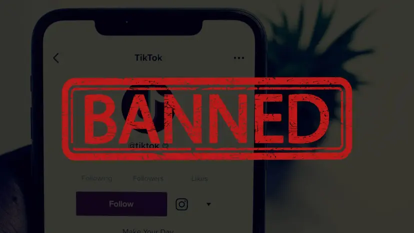 Phone showing a TikTok profile stamped with the word 'Banned' in red