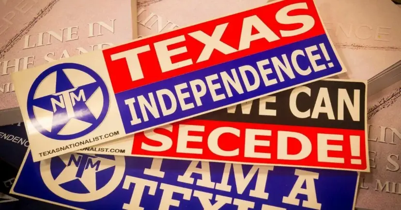 A pile of TNM bumper stickers, the top one reading 'Texas Independence!' beside the TNM star logo.