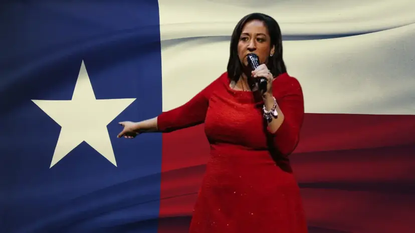 Bianca Gracia in a red dress speaks into a microphone in front of a large Texas flag.