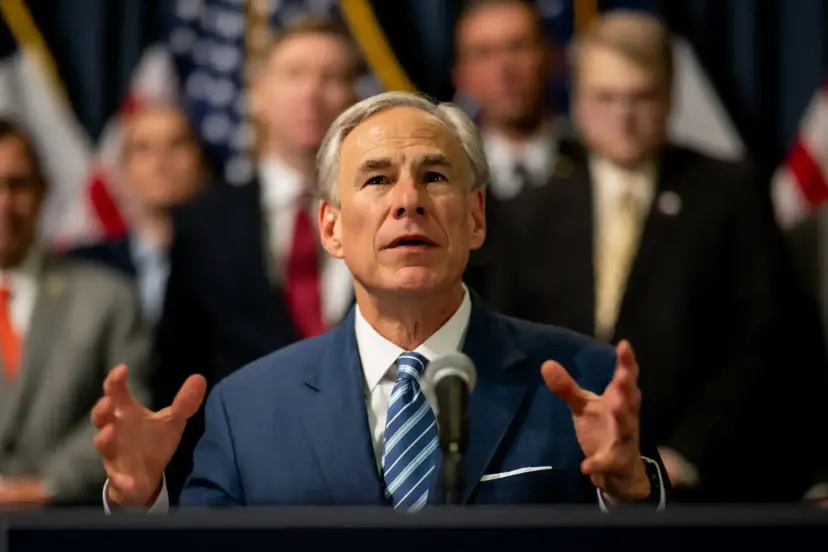 Texas Governor Greg Abbott speaks at a podium, gesturing with both hands, with officials standing behind him.