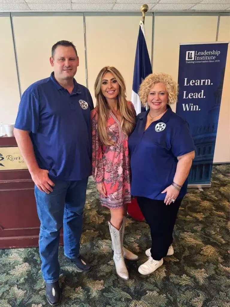 Three people pose beside a Texas flag and a Leadership Institute banner reading 'Learn. Lead. Win.'