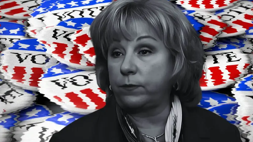 Black and white portrait of a woman with shoulder-length hair against a backdrop of red, white and blue 'Vote' buttons.