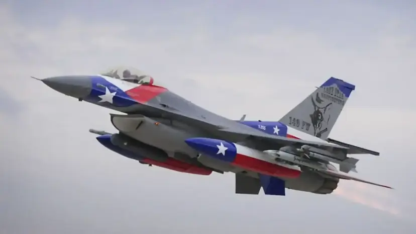 A fighter jet painted in Texas flag colors in flight