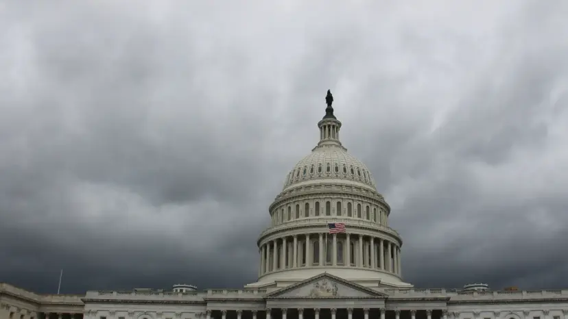 The Capitol dome in Washington under dark storm clouds