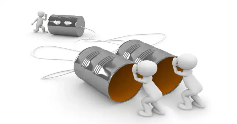 Two white 3D figures pushing large tin cans joined by string to another figure at a small can.