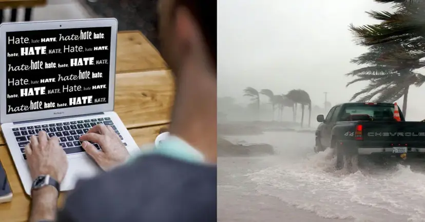 A person typing on a laptop filled with the word 'hate' beside a pickup truck in hurricane floodwater.