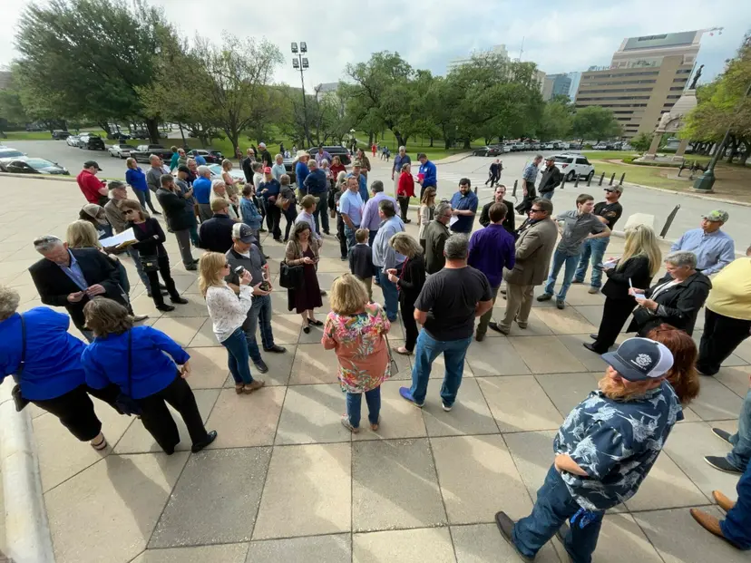 A crowd of supporters gathers on the plaza outside the Texas Capitol before going inside.
