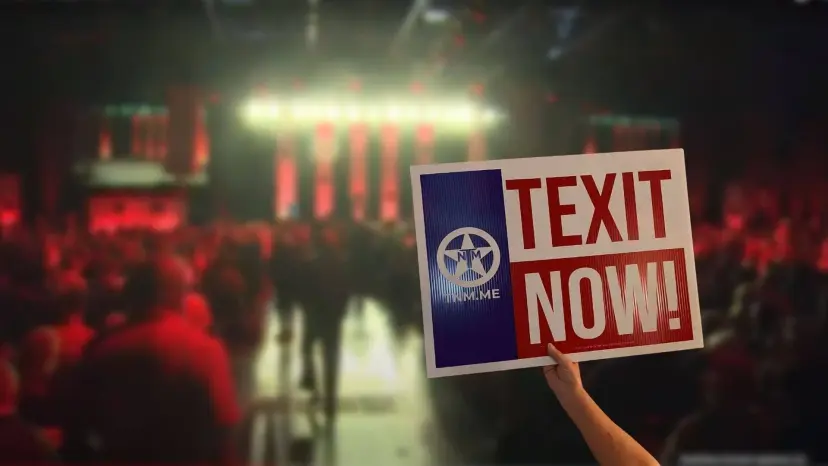 A hand holds up a TEXIT NOW! sign with the TNM logo above a crowded convention hall.