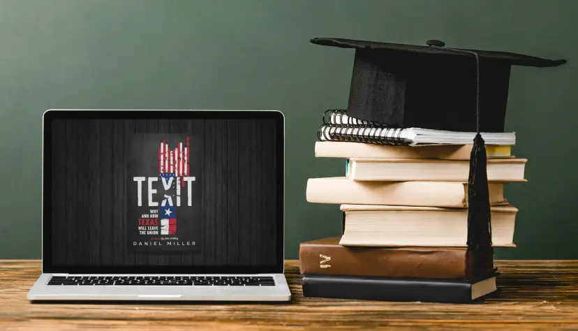 A laptop showing the cover of Daniel Miller's book 'TEXIT' beside a stack of books topped with a graduation cap.
