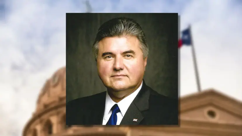 Portrait of Allen Fletcher in a suit and blue tie, set over a blurred Texas Capitol and flag.