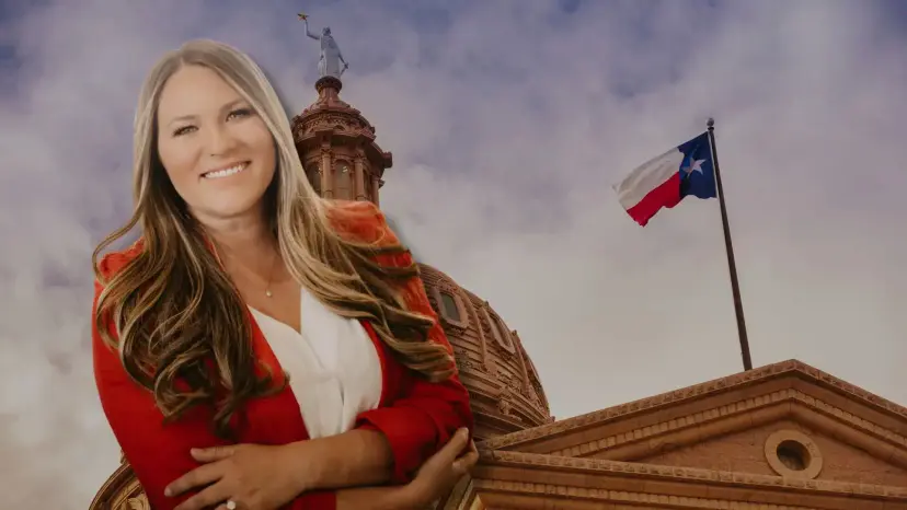 Stormy Bradley smiling in a red jacket in front of the Texas Capitol dome and a Texas flag.