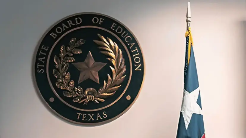 The Texas State Board of Education seal on a wall beside a Texas flag.