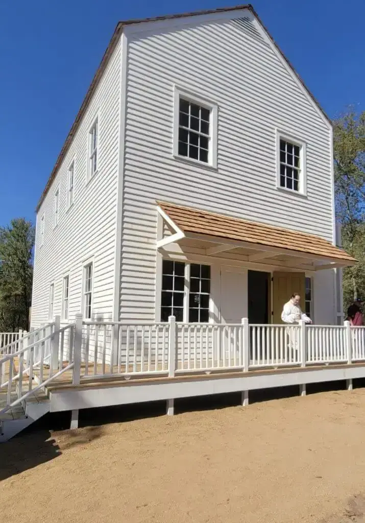 A reconstructed two-story white clapboard building with a railed porch and ramp at Washington-on-the-Brazos.