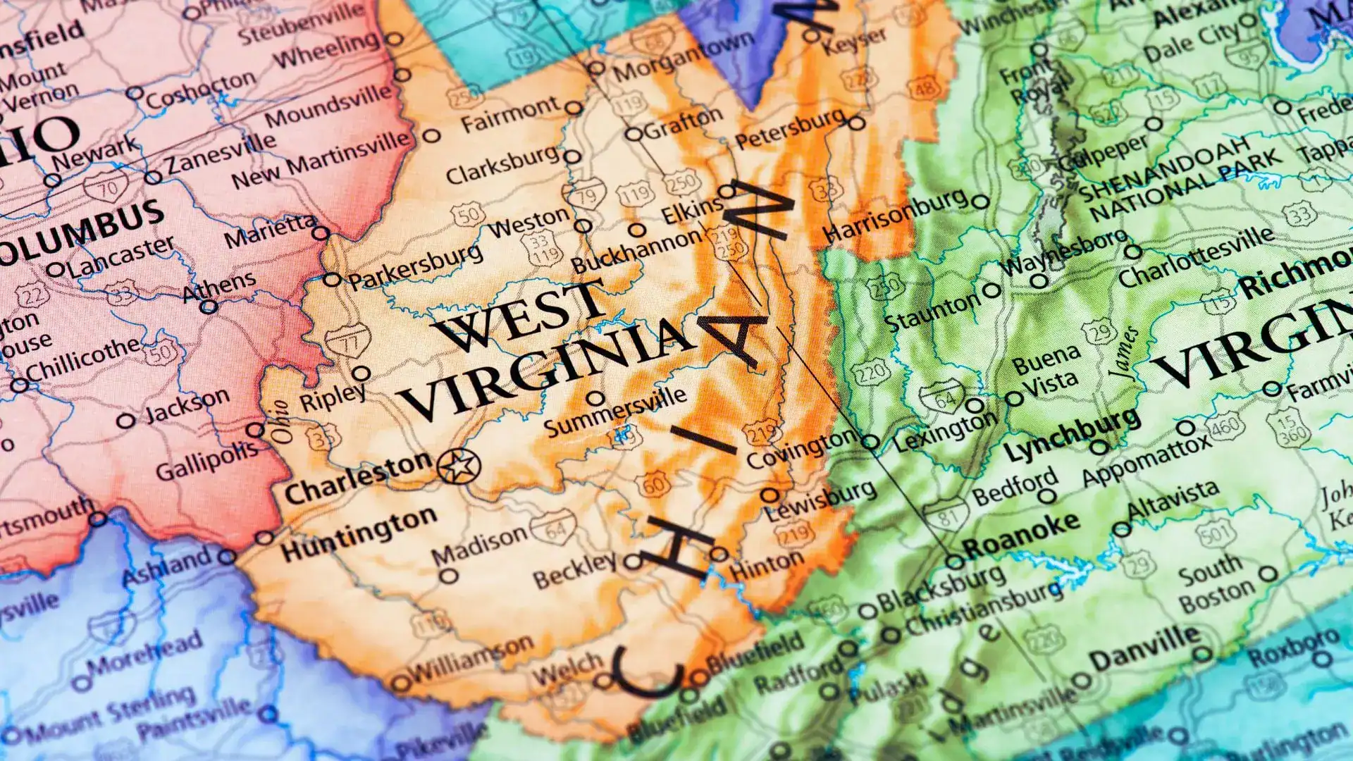 Close-up of a road map showing West Virginia, with neighboring Ohio, Virginia and the Appalachian Mountains.